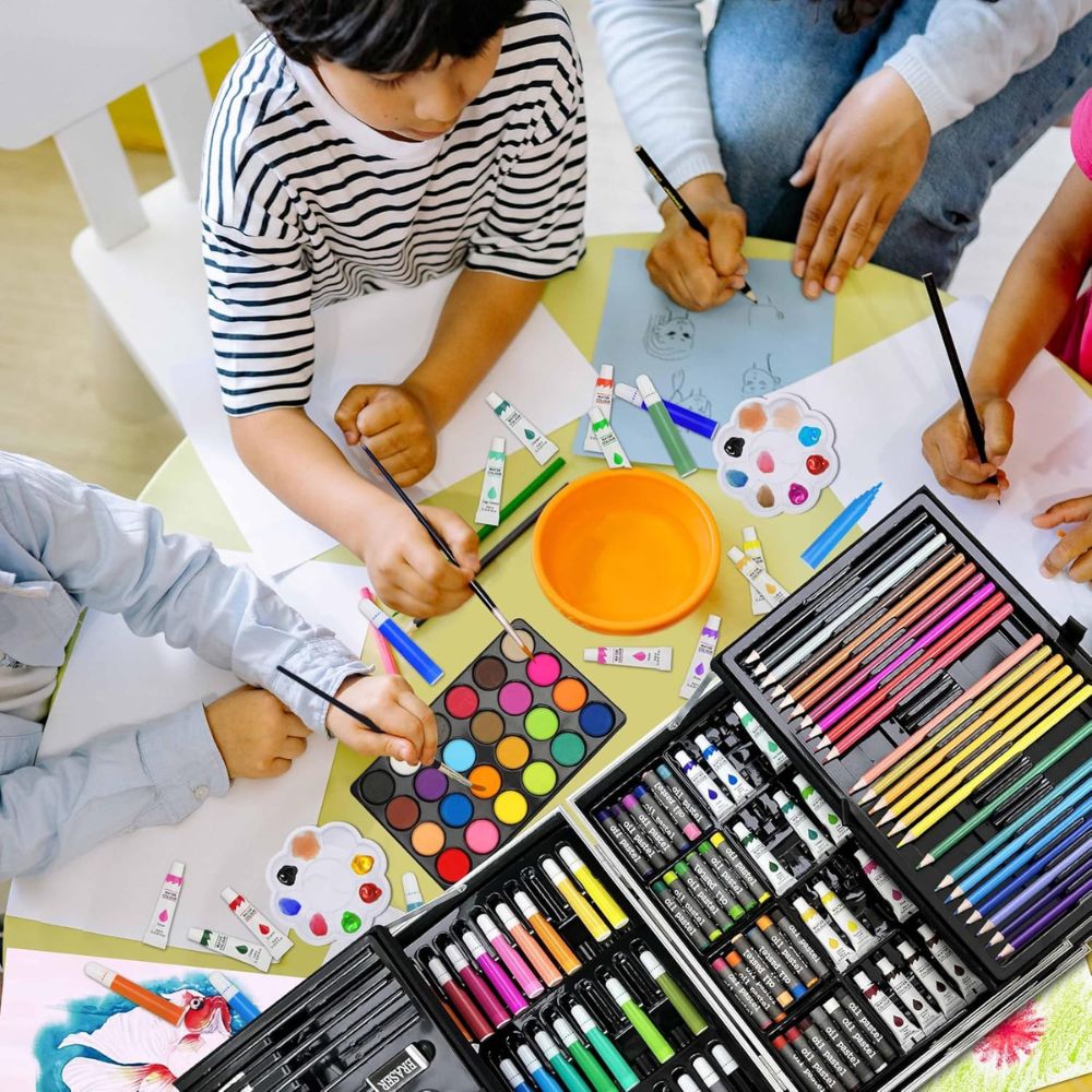 Children engaged in art activities with crayons, markers, and paint at a table.